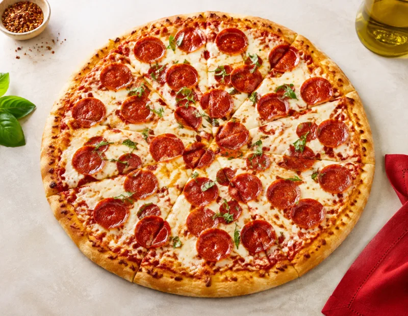 Pepperoni pizza with mozzarella and fresh basil